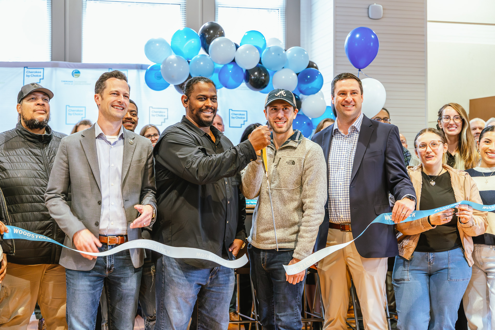 Ribbon cutting ceremony for a new coffee vendor inside a coworking and student center, with community members gathered to celebrate the opening.
